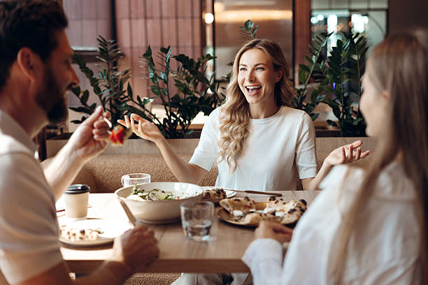 istock Friends enjoying lunch conversation in modern restaurant 2236551734