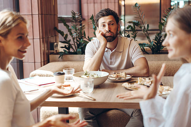 istock Man feeling bored as third wheel during friends lunch 2236551758