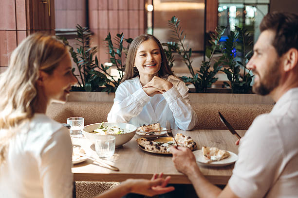 istock Friends enjoying restaurant meal sharing pizza and salad 2236551760