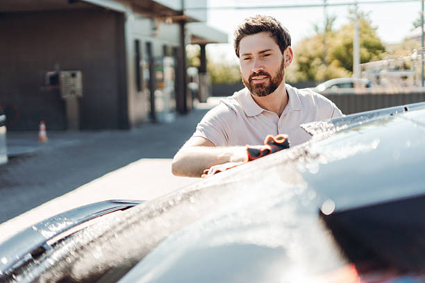 istock Man washing car with microfiber cloth at self-service car wash 2236553204