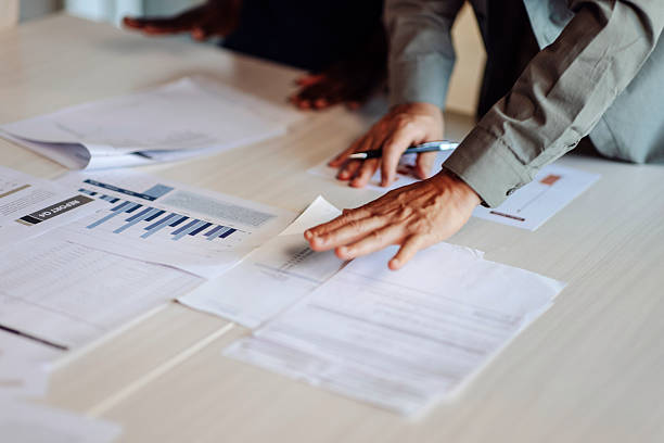 Business Team Analyzing Financial Reports on Desk During Meeting