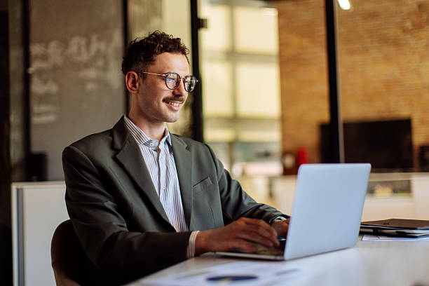 istock Confident Professional Working at Laptop in Modern Office Environment 2236553822