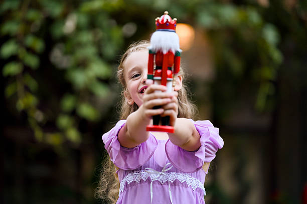 istock Smiling girl holding nutcracker Christmas holiday toy 2236556621