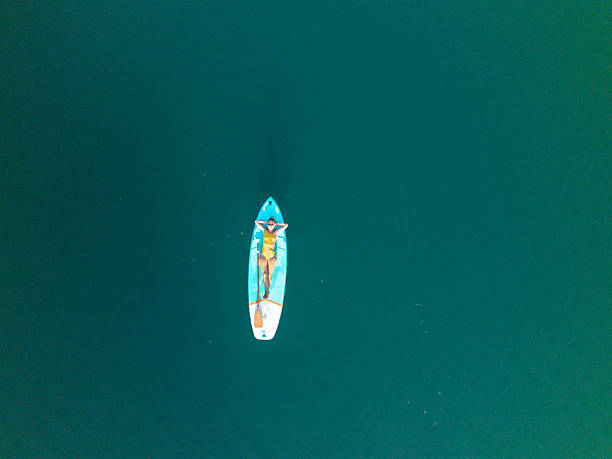istock Woman Relaxing on Paddleboard in Calm Water 2236560991