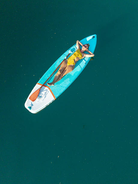 istock Woman Relaxing on Paddleboard in Calm Water 2236561073