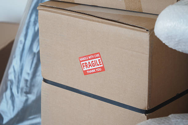 istock Handling fragile boxes with care during a move in a new home 2236569718