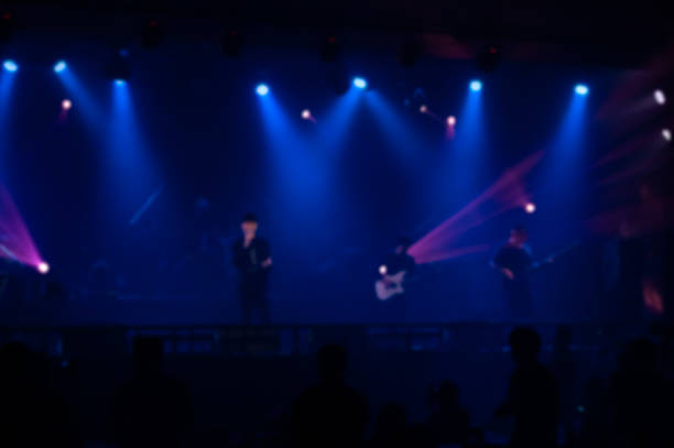 Abstract blurred image background of concert lights on stage with laser rays. Party, concert and entertainment concept