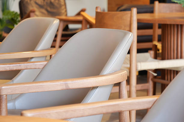 Comfortable wooden chairs are neatly arranged in a modern space.