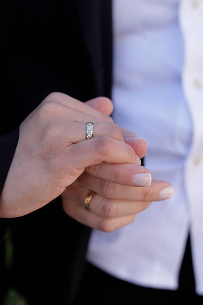 istock Couple showing wedding rings while holding hands 2236571460