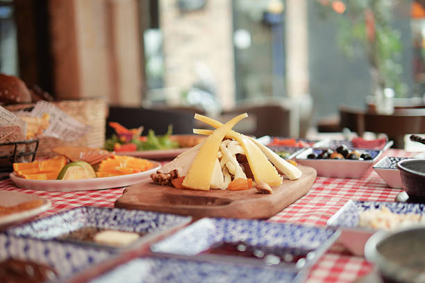 istock Delicious cheese platter served with fruits and bread at dining table 2236573077