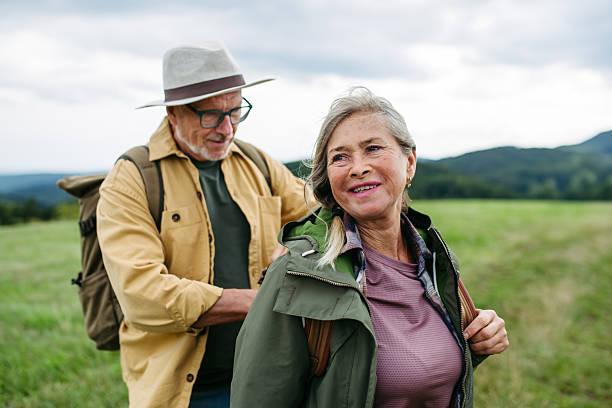 istock Older couple on group trip in autumn nature. 2236574222