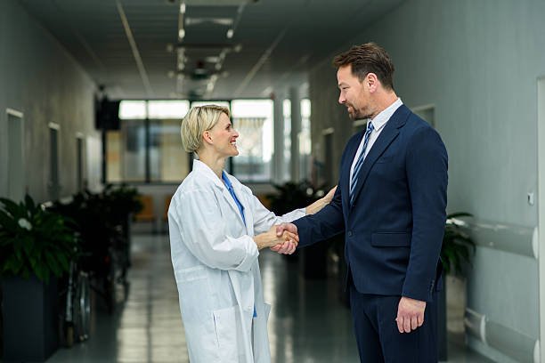 istock Pharmaceutical sales representative introducing new medication to female doctor. 2236574595
