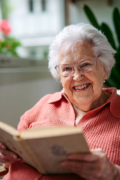 istock Senior lady at home, reading book. 2236576147
