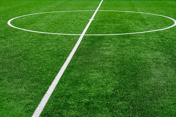 istock Soccer field with green grass and white line 2236577706