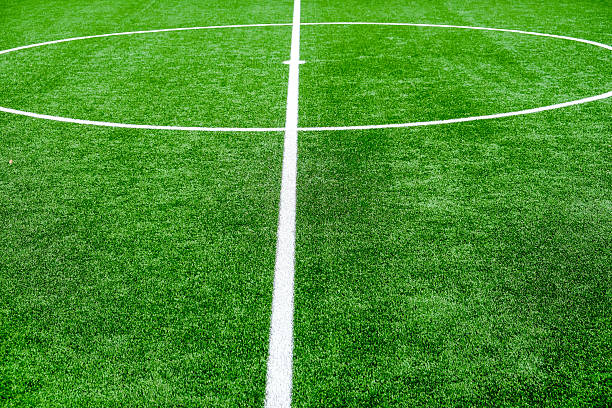 istock Soccer field with green grass and white line 2236577758