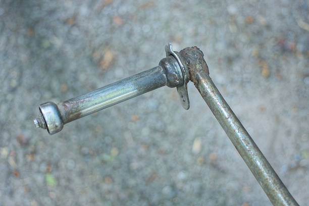 one old broken bicycle pedal made from a metal pin on a city street