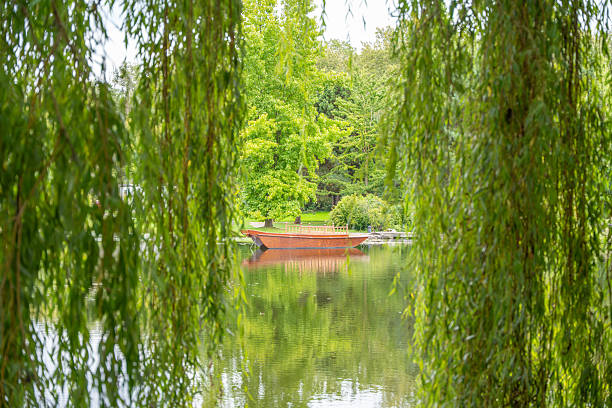 Düsseldorf, Germany - June 8, 2014: View over mere of castle Benrath in Düsseldorf at summertime. View from back of castle. Around mere people are walking - some are sitting on benches.