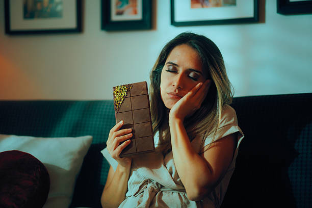 istock Lady Suffers from a Toothache From Eating too Much Sweets 2236580375