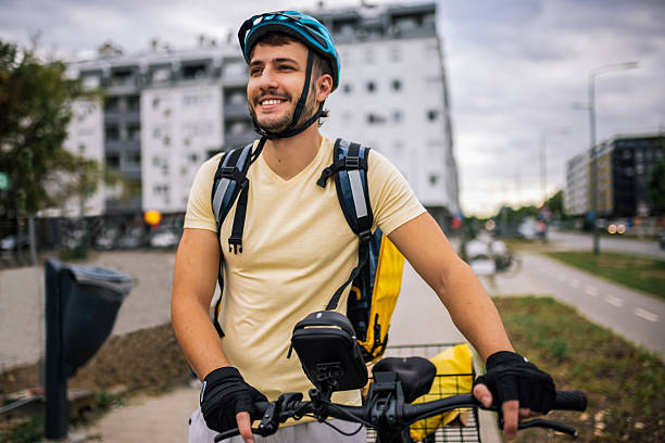 istock Courier on bicycle rides through urban streets, carrying delivery backpack, concept of fast food delivery, urban transport, courier job, modern city lifestyle. 2236581900