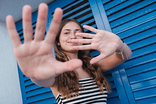 istock Young woman framing face with hands smiling. 2236582464