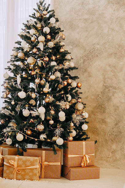 istock Christmas tree decorated with gold and white ornaments, presents underneath for Holiday celebration, festive interior design concept. 2236582592