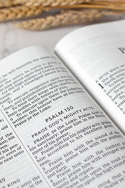 istock Psalm 150, praise God's mighty acts in open holy bible book 2236582745