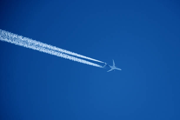 istock Airplane in the blue sky with contrail. 2236583026