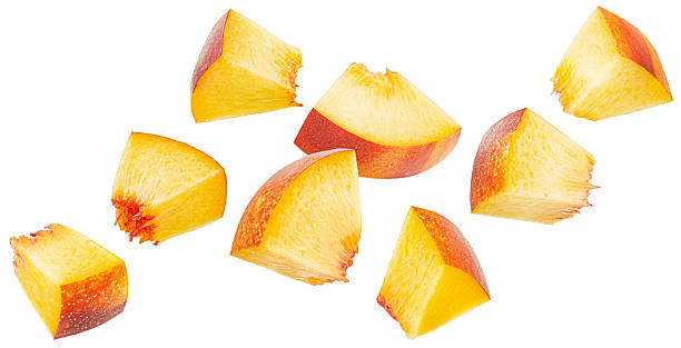 istock Falling peach cubes isolated on white background with clipping path, fresh nectarine slices 2236584359