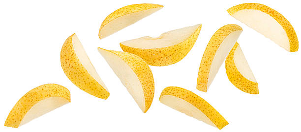 istock Falling yellow pear slices isolated on white background, full depth of field 2236584415