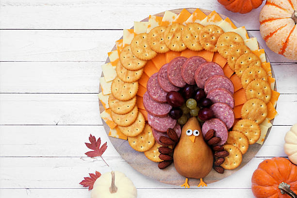 istock Thanksgiving turkey theme cheese board. Top down view table scene on a white wood background. 2236585284