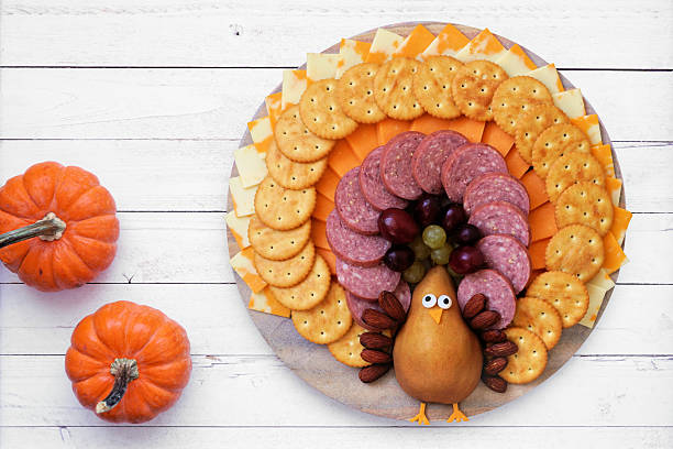 istock Thanksgiving turkey theme cheese board. Top view table scene on white wood. 2236585530