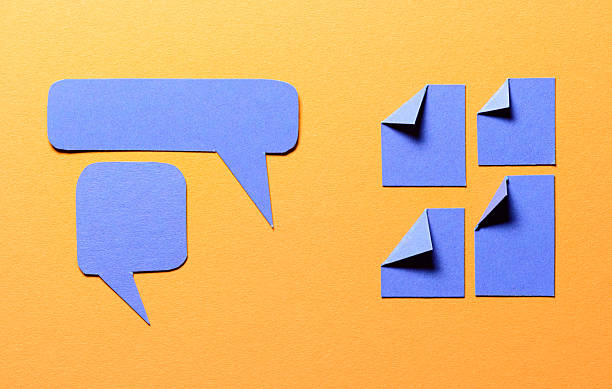 Blue speech bubbles and paper memo notes with folded dog-ear earmark and copy space for text on orange background, communication dialog concept top view flat lay