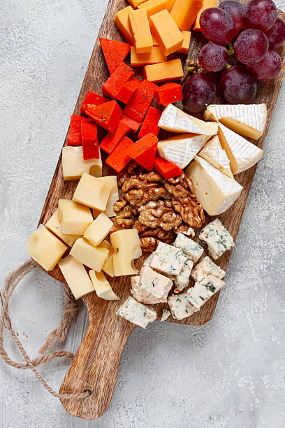 istock Assorted cheese on a wooden board, with grapes and walnuts, appetizer, no people. 2236587137