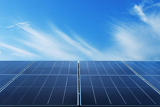 istock Rows of solar panels stretching under clear blue sky representing renewable future 2236587809