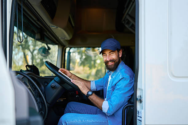 istock Happy truck driver using digital tablet in cabin 2236588281
