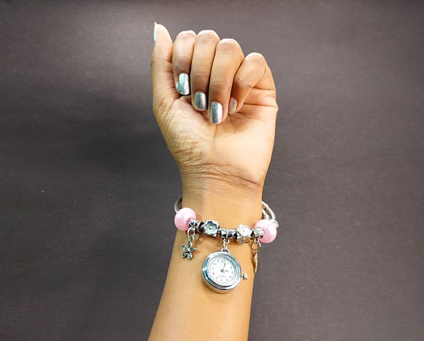 istock Hand Adorned with Charm Bracelet and Watch 2236588318