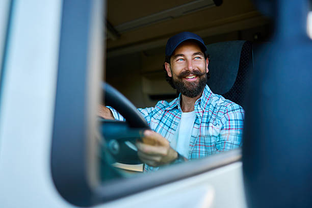 istock Happy truck driver smiling in vehicle 2236588548
