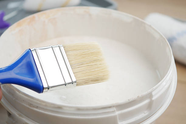 istock Painting activity with brush and white paint in a clean workspace 2236589163