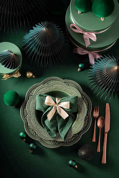 Unique dark green Christmas tableware with tableware and presents.