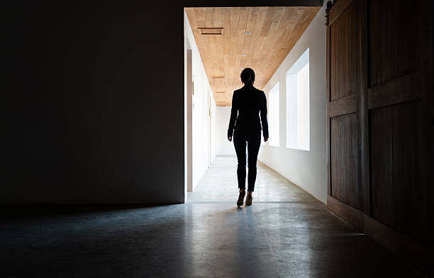istock Woman walking to the bright corridor 2236590978