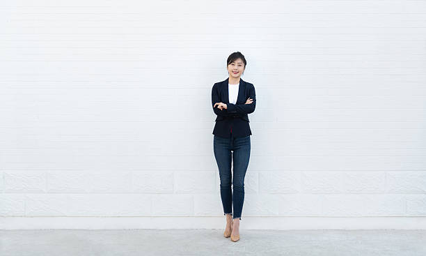 istock Confident woman standing with arms crossed 2236590991