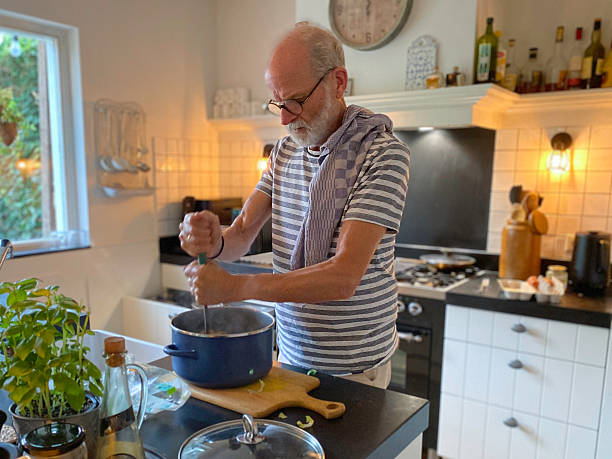 istock Senior Man making Endive Stew on a Sunday afternoon. 2236591129