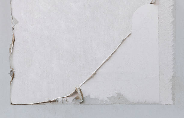 istock Weathered and torn ads poster old paper on cement wall. Abstract grunge 2236591226