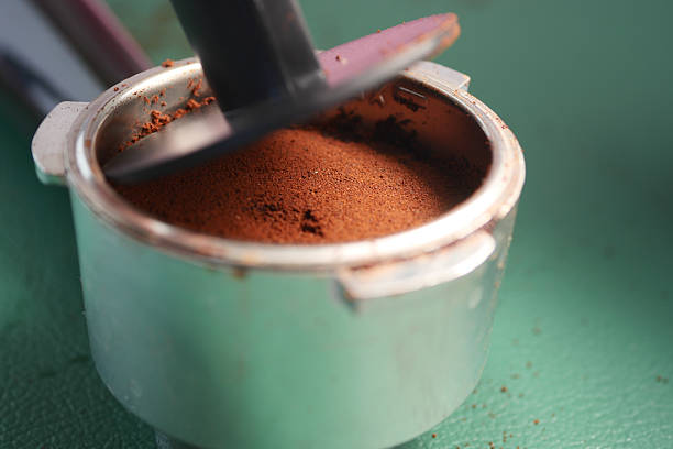 Grinding coffee to create rich grounds for brewing a flavorful beverage.