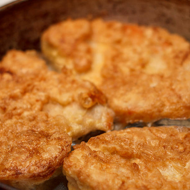 istock Golden fried chicken cutlets in a skillet. Crispy texture and appetizing appearance 2236592176