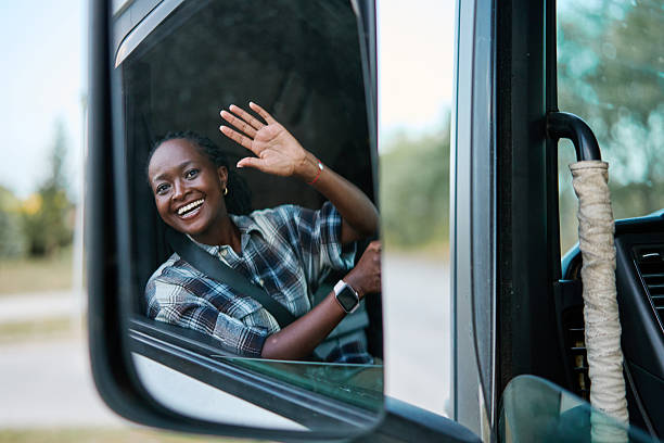 istock Cheerful truck driver waving from cabin window 2236592204