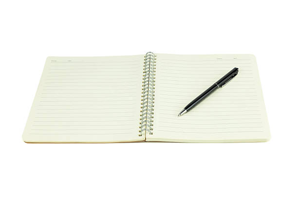 istock Open spiral notebook with blank lined pages and black pen isolated on white background with clipping path. 2236592355