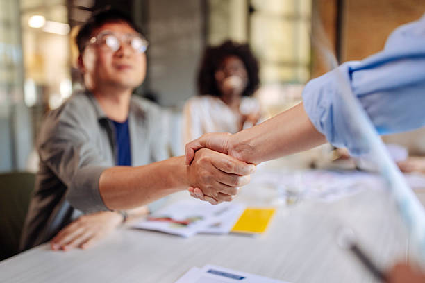 istock Business Professionals Shaking Hands During a Collaborative Team Meeting in the Workplace 2236594815