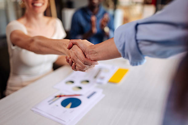 istock Friendly Handshake Between Two Professionals at a Business Meeting Desk 2236594817