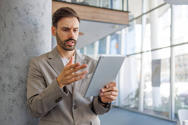 istock Concerned businessman discussing during a video call on tablet 2236596482
